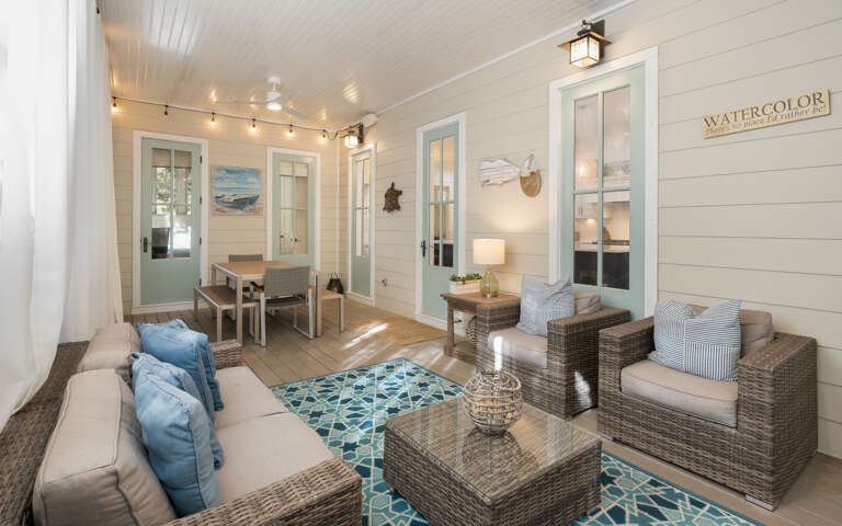 Unwind in your bright, coastal living space with wicker seating and cheerful blue accents that perfectly capture beach house charm.