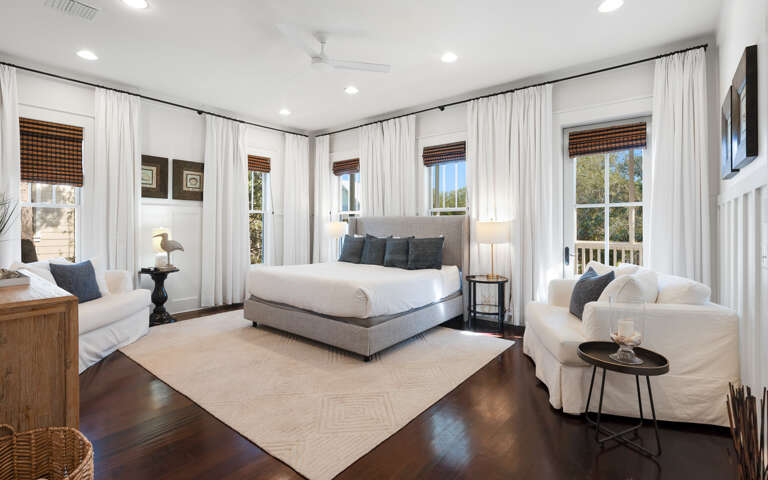 Your spacious master bedroom features soaring ceilings, abundant natural light, and elegant coastal styling for the perfect retreat.