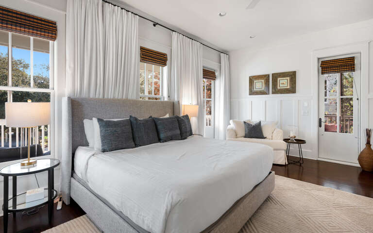 Rest peacefully in your serene bedroom featuring crisp white linens, natural light, and a cozy reading nook by the window.