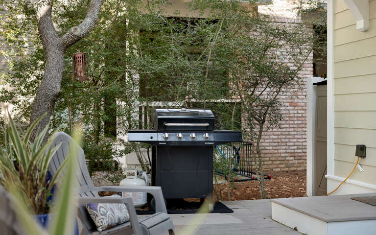 Fire up the grill for your perfect outdoor feast in this private patio space surrounded by lush greenery.