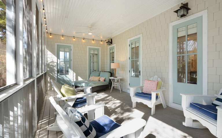 Relax in your private screened porch with cozy seating, string lights, and coastal charm—perfect for morning coffee or evening retreats.