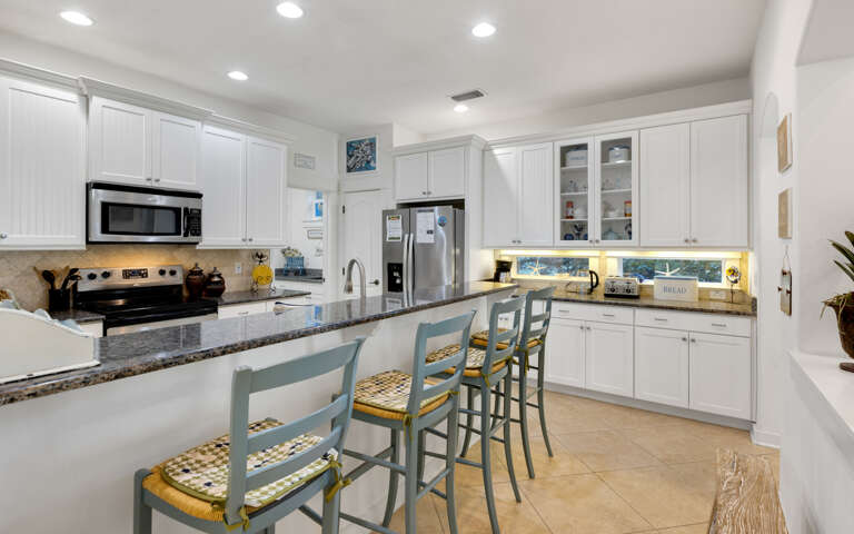 Your bright, fully-equipped kitchen welcomes you to cook meals together, featuring granite counters and breakfast bar seating.