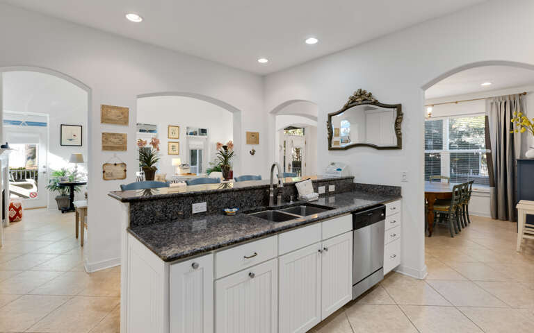 Cook your favorite meals in this elegant kitchen featuring granite countertops, stainless steel appliances, and an open island perfect for gathering.