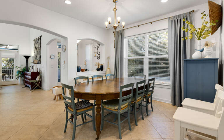 Gather around this welcoming dining table where your group can enjoy meals together in this bright, thoughtfully designed space with charming archways.