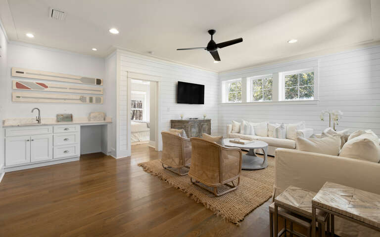 Sink into plush cream seating while natural light streams through large windows, creating your perfect space to unwind and connect.