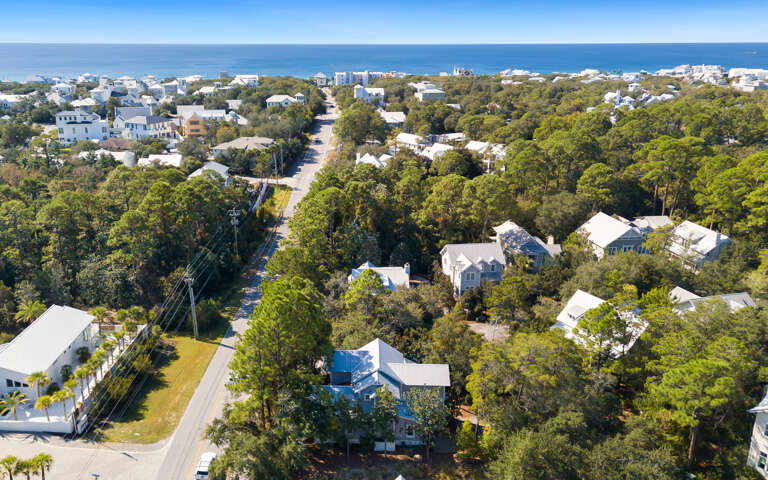 Coastal community nestled among lush trees, with beautiful beach access just a short walk away through this charming neighborhood.