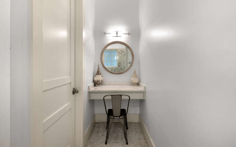 Your private vanity nook features elegant lighting and a cozy chairâperfect for morning routines or evening touch-ups.