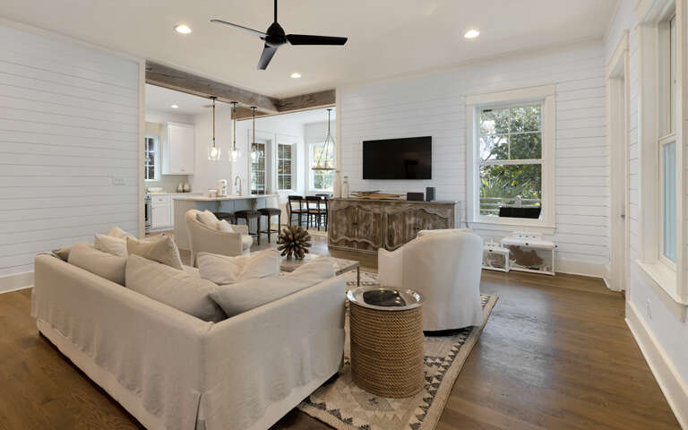 Relax in your bright, open living space with comfy seating, modern kitchen, and charming shiplap walls that create the perfect coastal retreat.