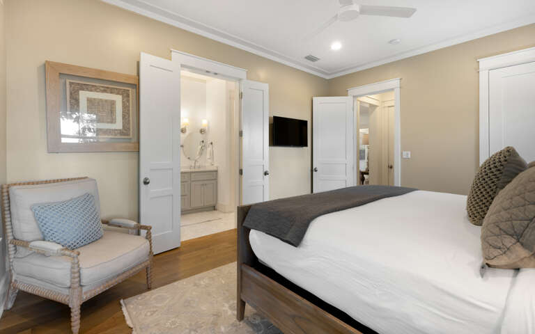 Settle into your elegant bedroom featuring warm wood floors, cozy seating, and your own en-suite bathroom for ultimate comfort.