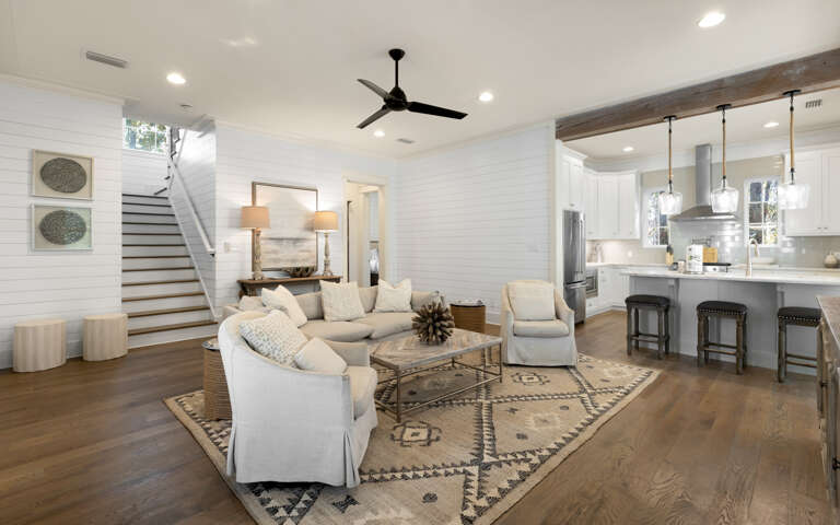 Unwind in your stylish open-concept living space where modern comfort meets coastal charm, complete with plush seating and gourmet kitchen.