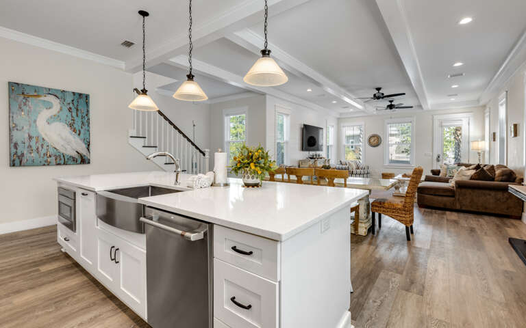 Step into your bright, modern sanctuary where gleaming white counters invite morning coffee preparation and evening meal gatherings.