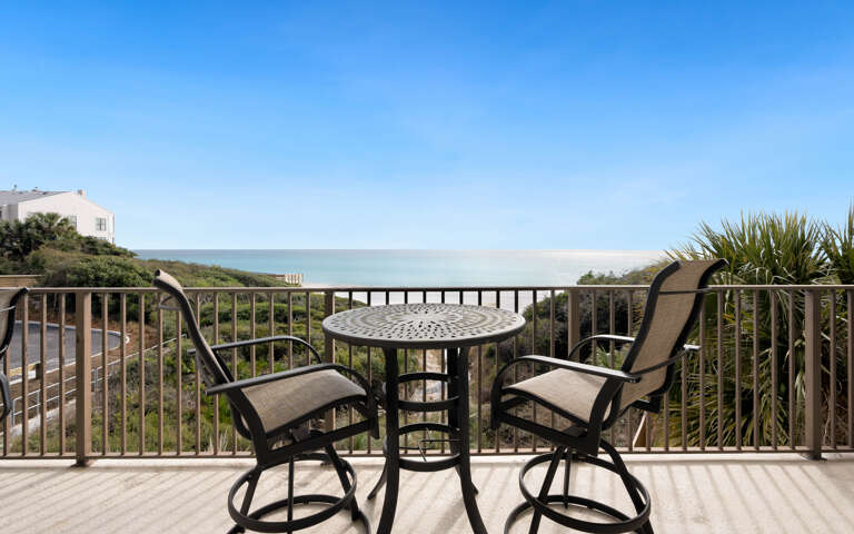 Beautiful ocean views stretch endlessly from this private balcony with comfortable seating for morning coffee or evening relaxation.