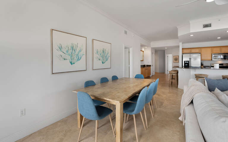 Gather around this spacious dining table where memorable meals and conversations await, perfectly positioned in your open-concept living space.
