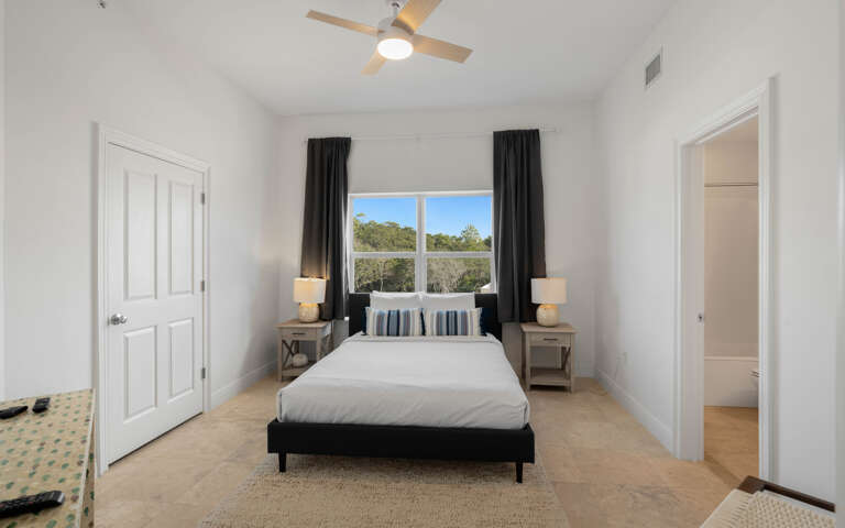 Rest peacefully in your bright bedroom with crisp linens and garden views through oversized windows.