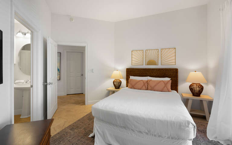 Sink into crisp linens and soft pillows in your serene bedroom, where warm lighting and thoughtful touches create the perfect retreat.