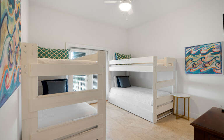 Your kids will love these cheerful bunk beds, perfectly set up for a cozy night's sleep after beach adventures.