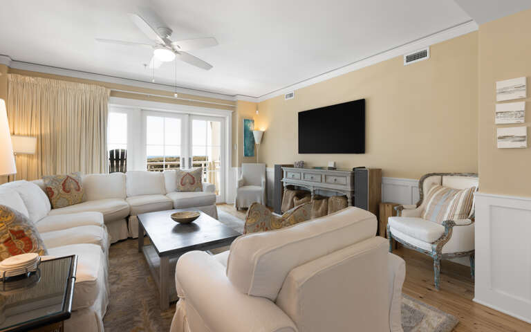Sink into plush sofas in your elegant living room, where the fireplace adds warmth and large windows frame beautiful views.