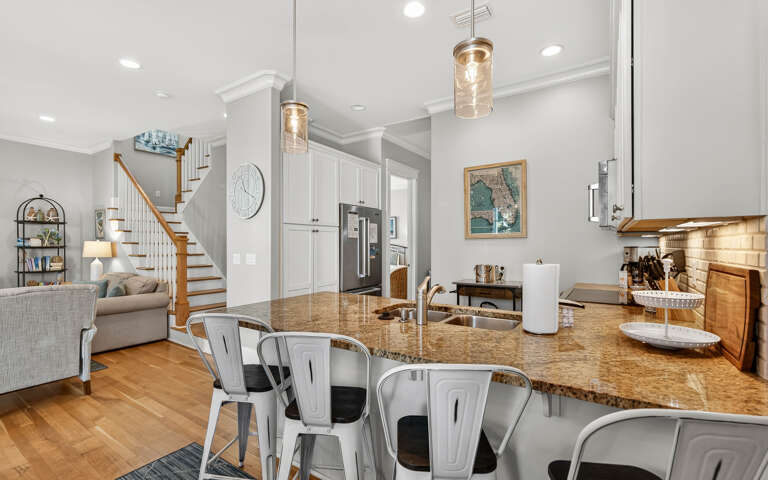 Gather around this stunning granite island where memories are made over morning coffee and evening conversations in your open-concept haven.