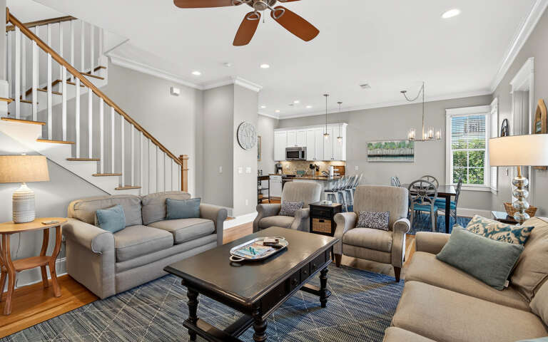 Relax in your spacious open-plan living area with comfortable seating, modern kitchen, and stylish touches that make this feel like home.