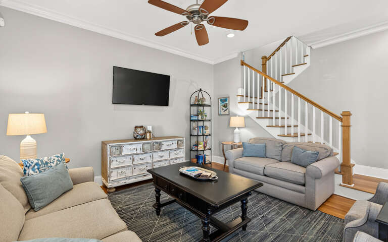Sink into plush seating while enjoying your favorite shows on the wall-mounted TV in this inviting living space.