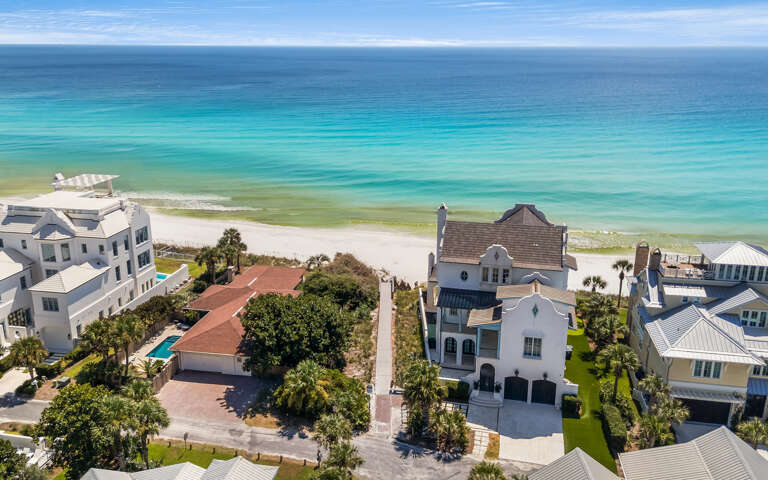 Aerial View Of Beachside Buildings Bordering Brilliant Blue Sea
