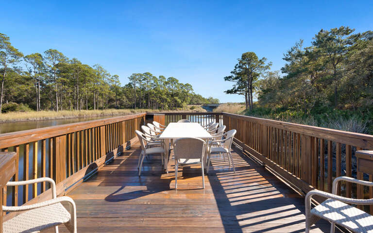 Waterfront deck where morning coffee tastes better surrounded by marshland views and gentle water sounds.