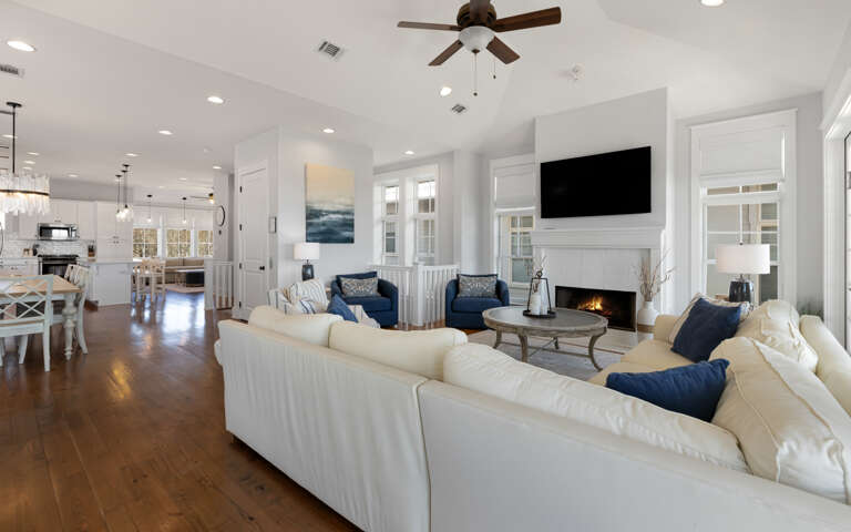 Relax in this bright, open living space featuring plush seating, a cozy fireplace, and seamless flow to your fully equipped kitchen.