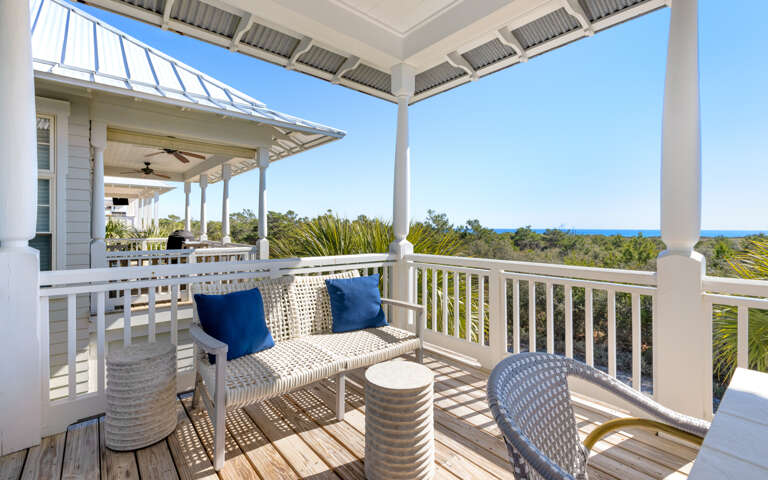 Relax on your private balcony with ocean views, where comfortable seating and coastal breezes create the perfect spot to unwind.
