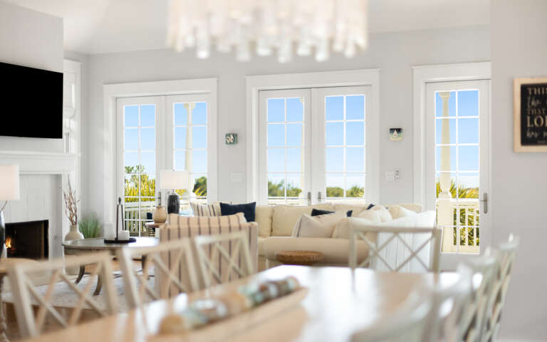 Sink into the plush sectional while natural light floods through French doors, creating your perfect spot to unwind with fireplace warmth nearby.