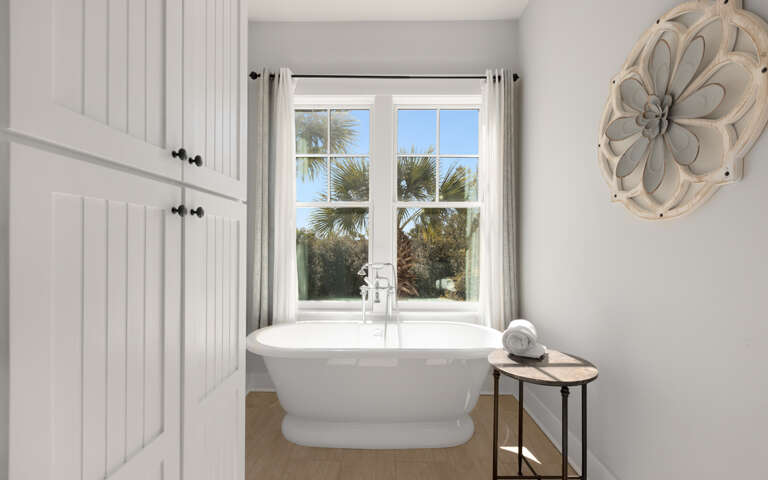 Soak in your elegant freestanding tub while gazing at swaying palms through the windowâpure tropical tranquility awaits.