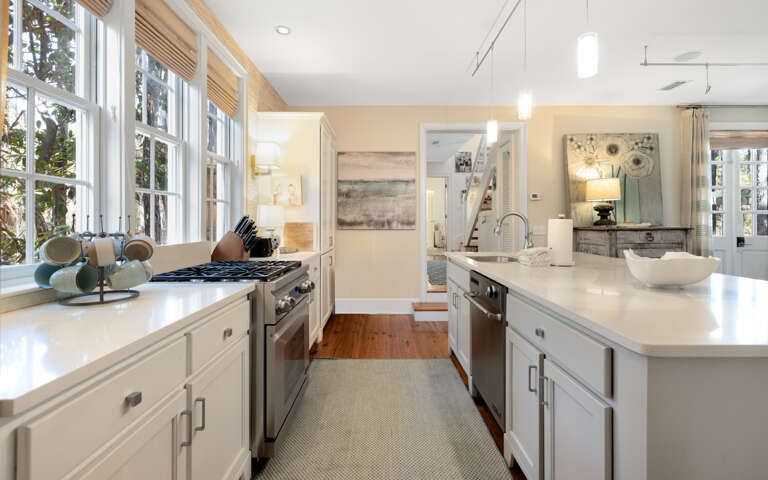 Cook with ease in this bright, open kitchen featuring modern appliances and pristine countertops flooded with natural light.
