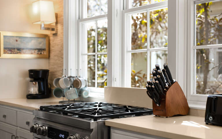 Your fully-equipped kitchen invites culinary adventures with professional-grade appliances, quality knife set, and sunlit workspace overlooking peaceful garden views.