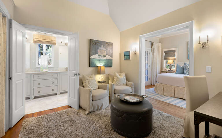Your elegant suite features a cozy seating area with soft armchairs, perfect for unwinding after exploring the area.