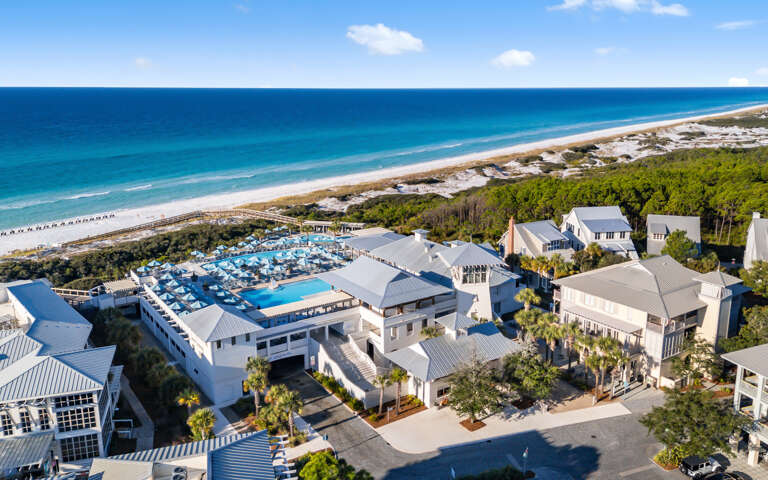 Stunning beachfront resort featuring pristine white sand beaches, crystal blue waters, and elegant coastal architecture surrounded by lush tropical vegetation.