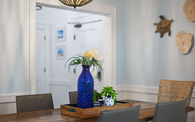 Your dining space welcomes you with coastal charmâfresh flowers and nautical touches create the perfect setting for memorable meals together.