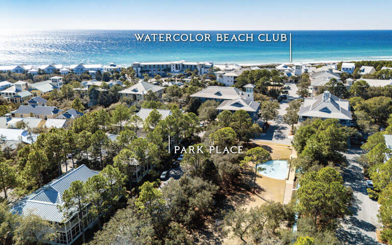 Aerial view of community with pristine white sand beaches and turquoise waters nearby.