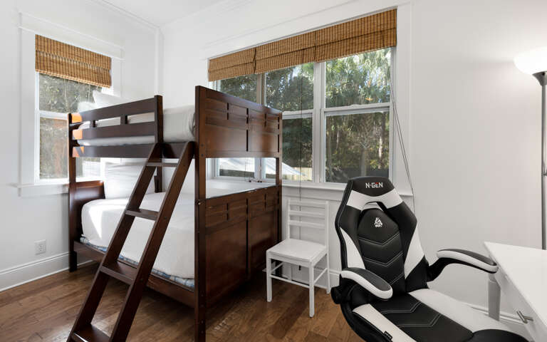 Your perfect space combines comfort and fun with cozy bunk beds and a gaming chair ready for your next adventure.