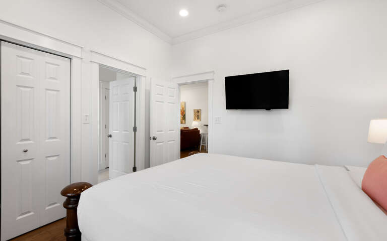 Unwind in your serene bedroom with crisp white linens, modern TV for entertainment, and abundant storage for all your belongings.