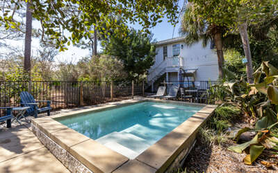 Dive into your private oasis surrounded by lush tropical landscaping and mature trees for ultimate relaxation.