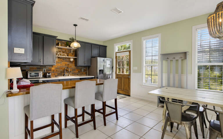 Your fully equipped kitchen awaits with modern appliances, granite counters, and cozy breakfast bar seating for memorable meals.