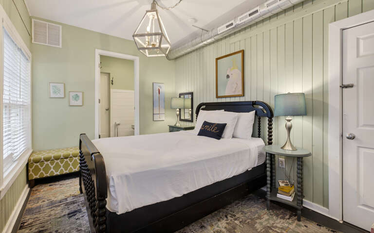 Unwind in your charming bedroom with crisp linens, warm lighting, and coastal cottage vibes that invite peaceful rest.