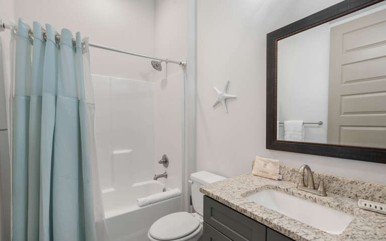 Refresh in your private bathroom with a soothing shower-tub combo and granite vanityâcoastal touches add charm.