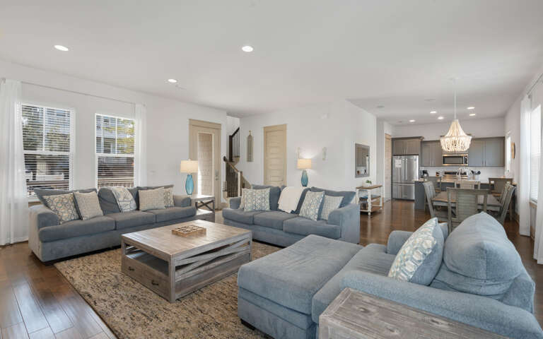 Relax in your spacious living room with plush seating and an open kitchen perfect for gathering with loved ones.