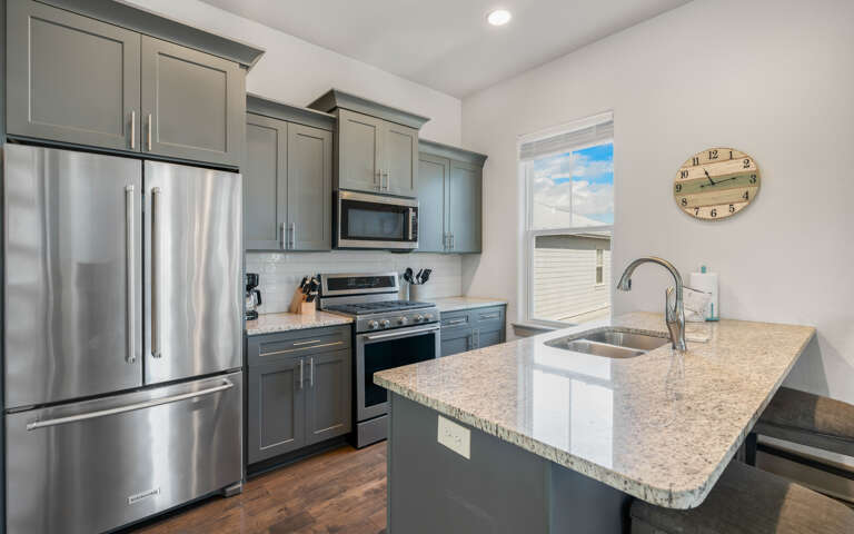 Step into your fully-equipped kitchen featuring granite countertops, stainless steel appliances, and everything you need to prepare memorable meals.