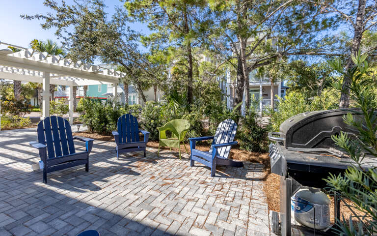Outdoor Seating Area With Chairs And Barbecue Grill