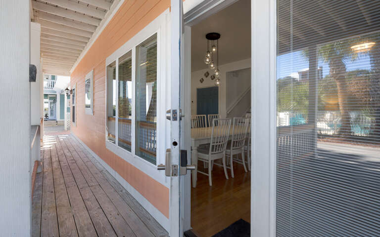 Step onto your private deck and into a bright dining space with elegant pendant lighting and waterfront views.