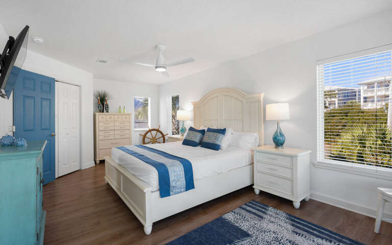 Sink into coastal comfort in your serene bedroom, where ocean-inspired blues meet crisp white linens for your perfect getaway retreat.
