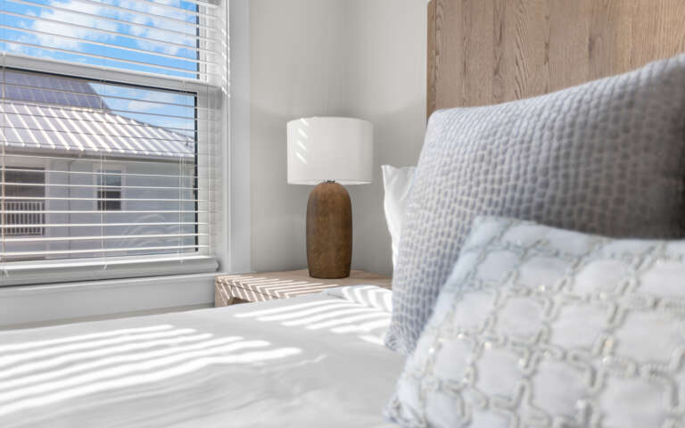 Sink into crisp white linens and wake to natural light streaming through your window, creating the perfect sanctuary for rest.