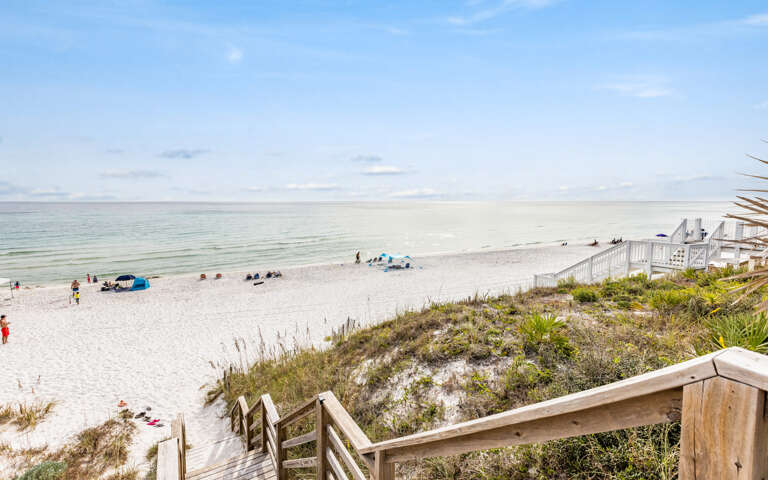 Beach View With Wooden Stairs And Visitors Beach View With Wooden Stairs And Visitors