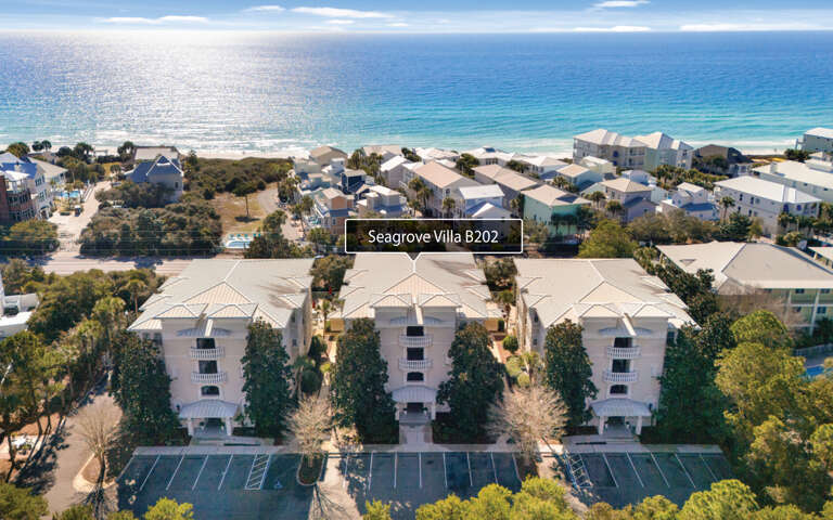 Aerial view of beachfront vacation rentals nestled among lush greenery, just steps from pristine white sand beaches and sparkling Gulf waters.